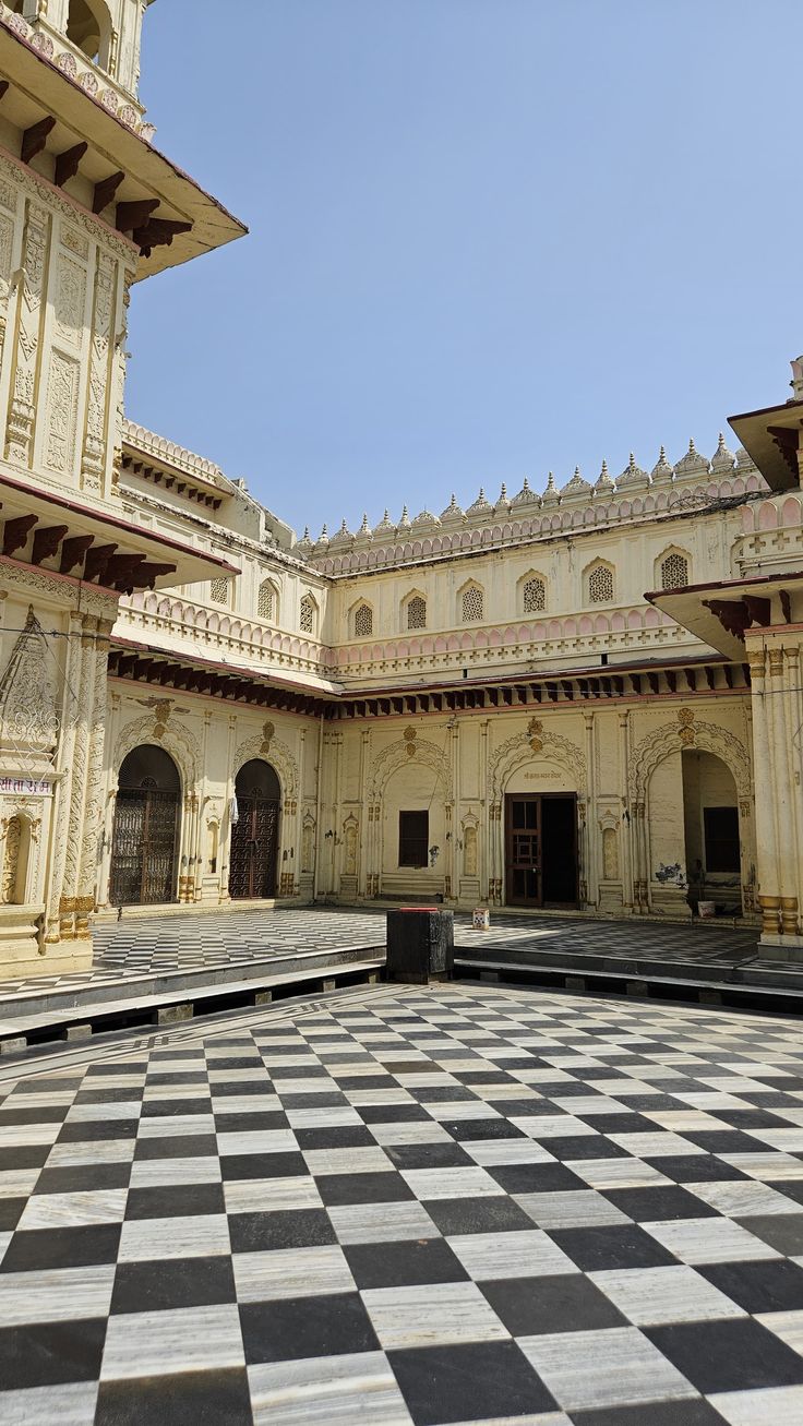 Kanak Bhawan — a painted temple courtyard with arched galleries on three sides
