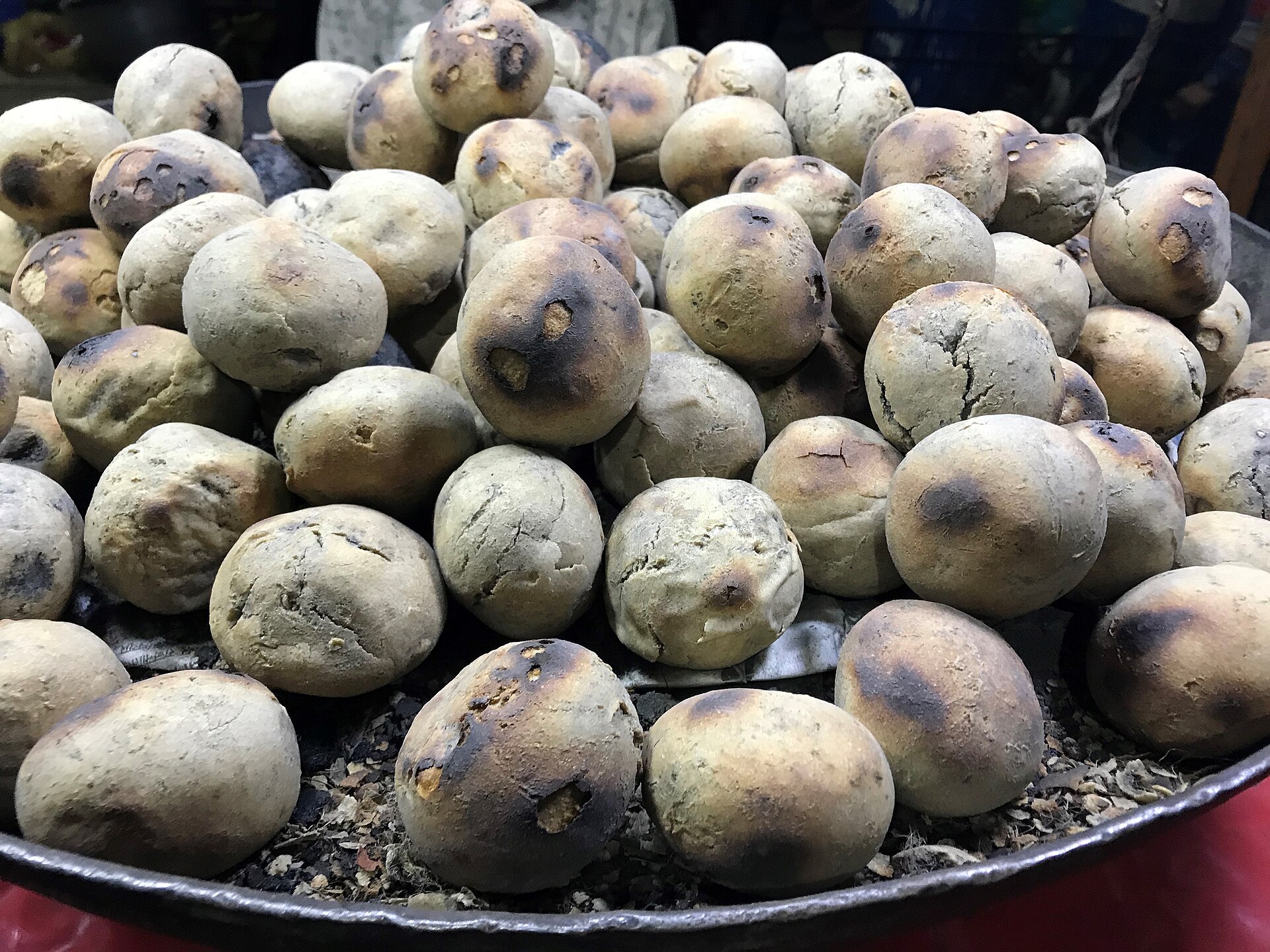 A tray of baked wheat baati, the bread served with chokha
